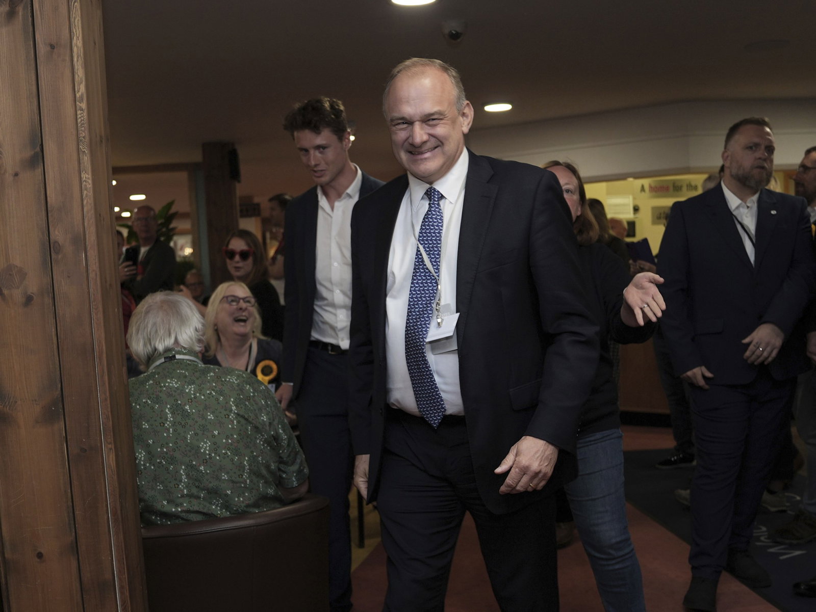 Man wearing suit looks at camera and smiles 