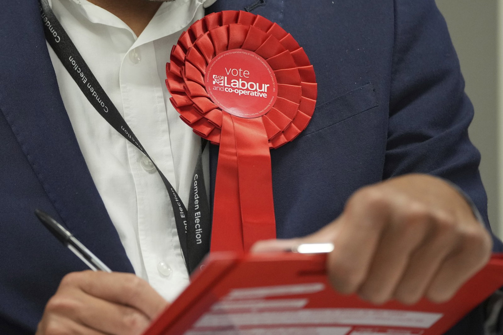 a red labour rosette on a lapel, close up